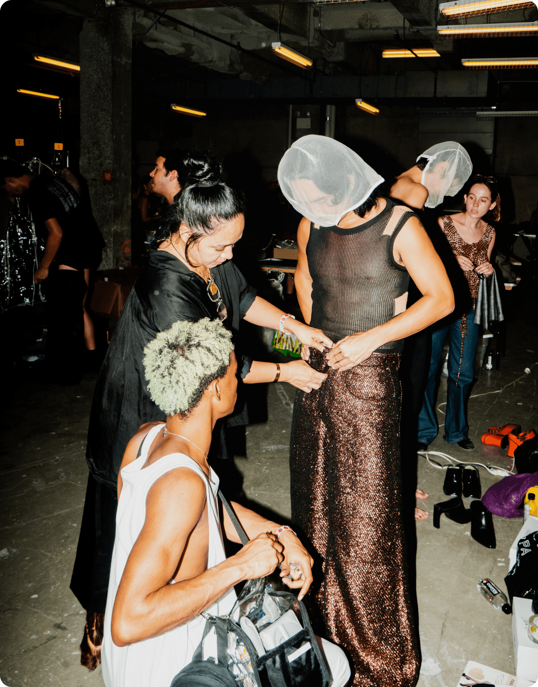 Avena Gallagher, lead stylist for Eckhaus Latta, adjusts a pair of 3D woven Tinsel pants on a model at the Rockefeller Center in Manhattan.